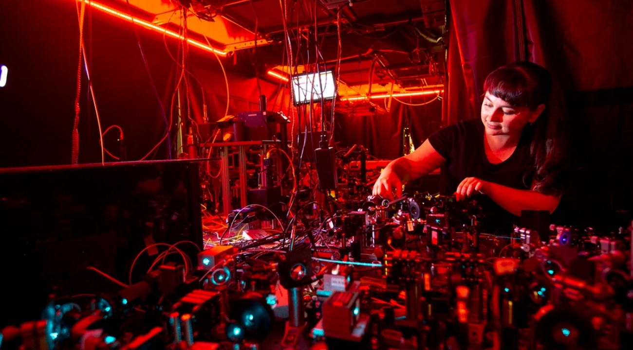 a student working on an optical bench in a lab